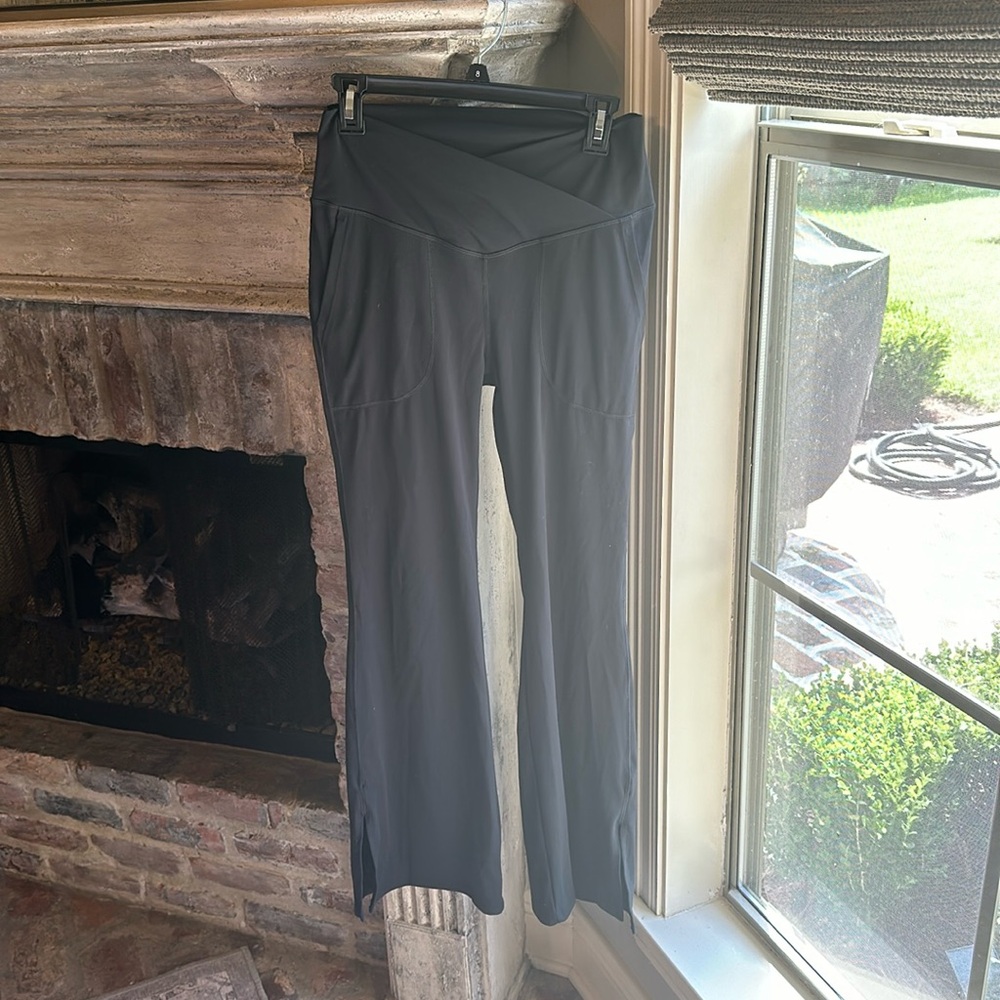 Halara crossover high rise black flare leggings, slit at bottom, pockets, medium